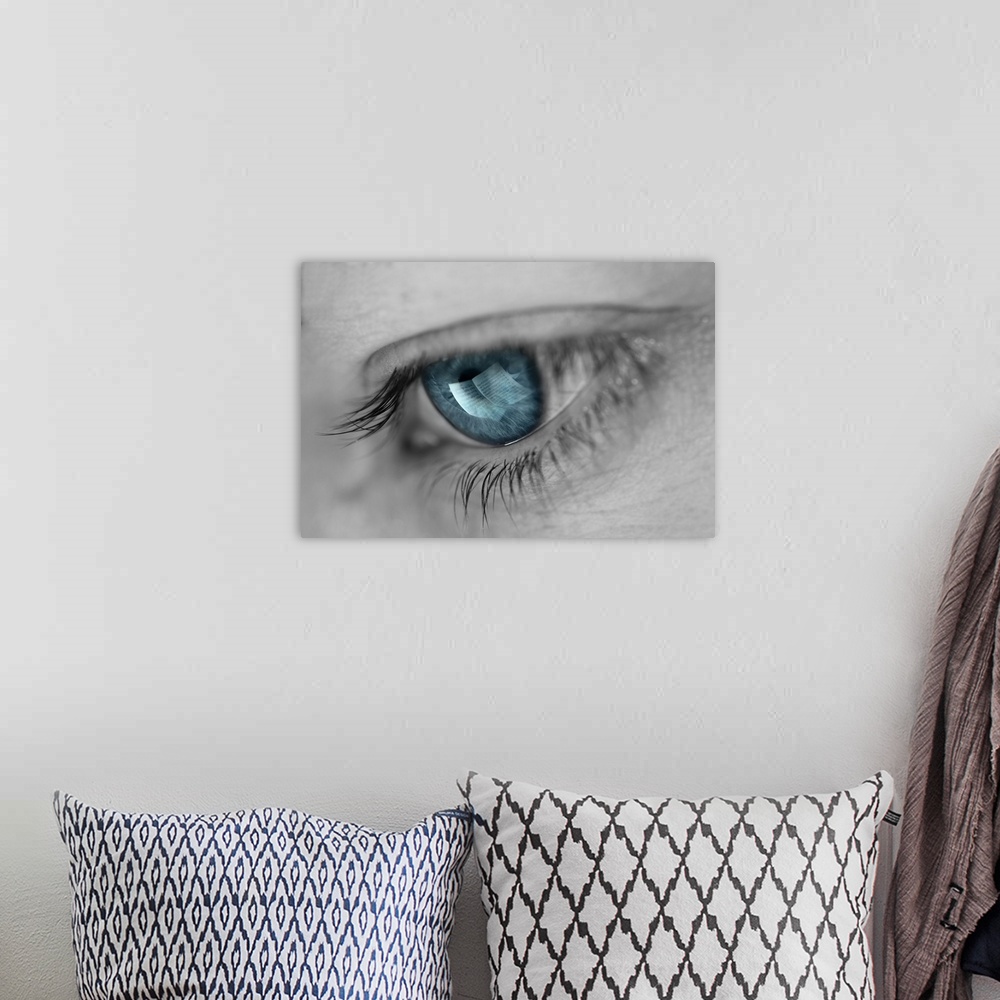 A bohemian room featuring A woman's eye with a turquoise iris and a reflection of sheet music.