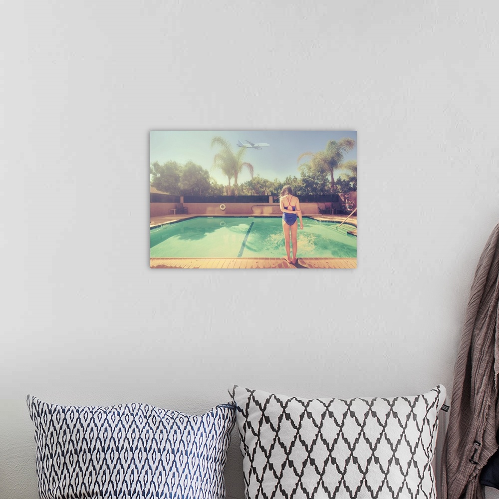 A bohemian room featuring A young girl looking at a pool in suburban Los Angeles.