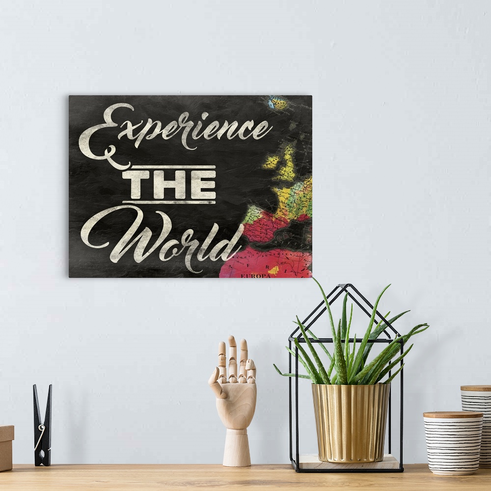 A bohemian room featuring "Experience the World" painted on a chalkboard background with a colorful map on the right side.