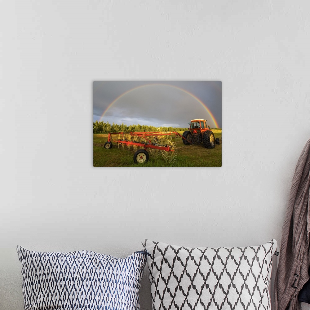 A bohemian room featuring A rainbow appears in the sky over a tractor which has just raked a field of hay; Delta Junction, ...