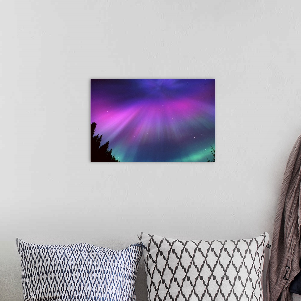 A bohemian room featuring This landscape photograph captures the glow of the Northern lights and the speckles of stars beyo...