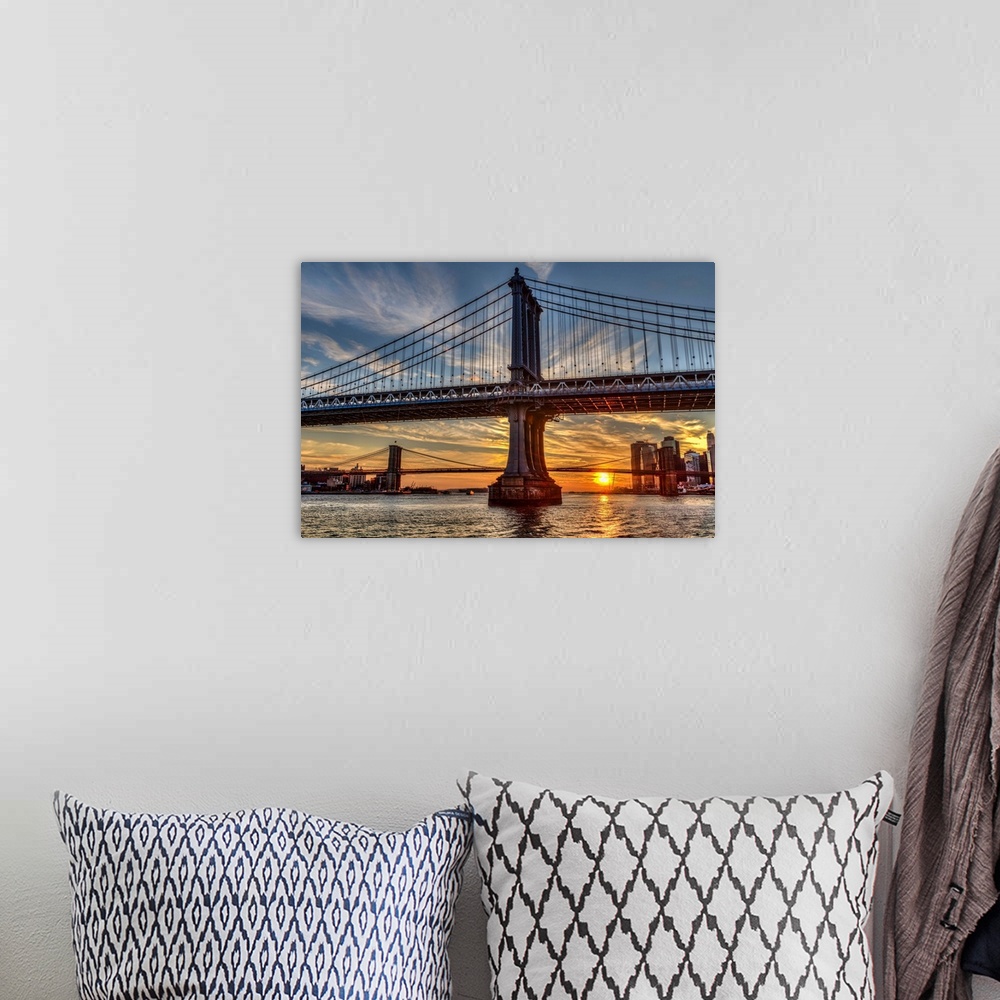 A bohemian room featuring Sun setting behind Manhattan and Brooklyn Bridges; New York City, New York, United States of America