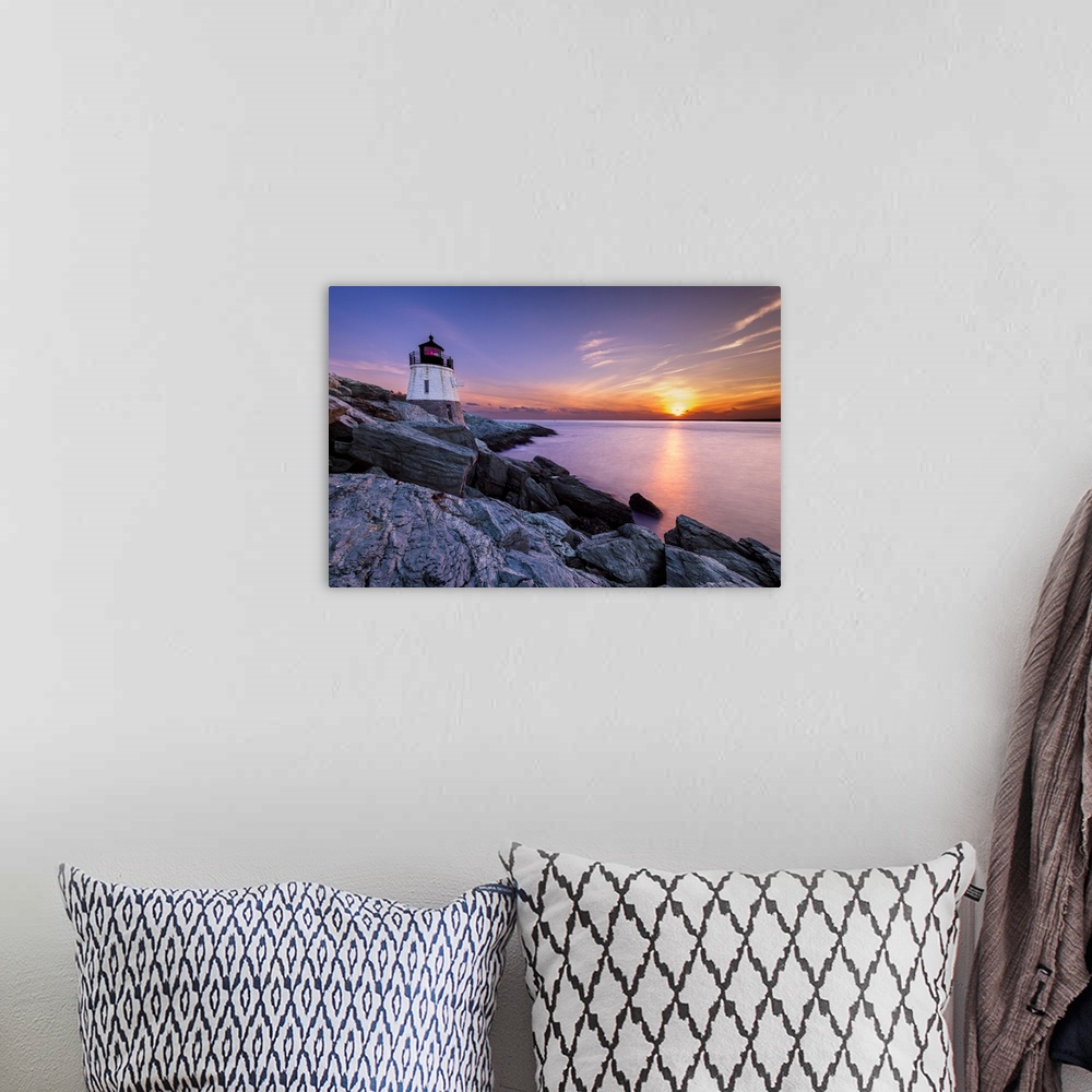 A bohemian room featuring Long exposure photograph of a lighthouse on a rocky cliff with a beautiful sunset over the water.