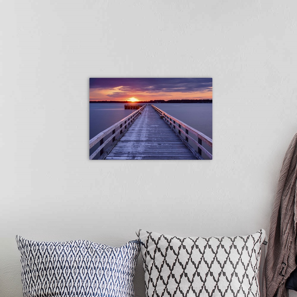A bohemian room featuring Photograph of a long, wooden pier at Fort Foster, Maine, with a pink and purple sunrise.