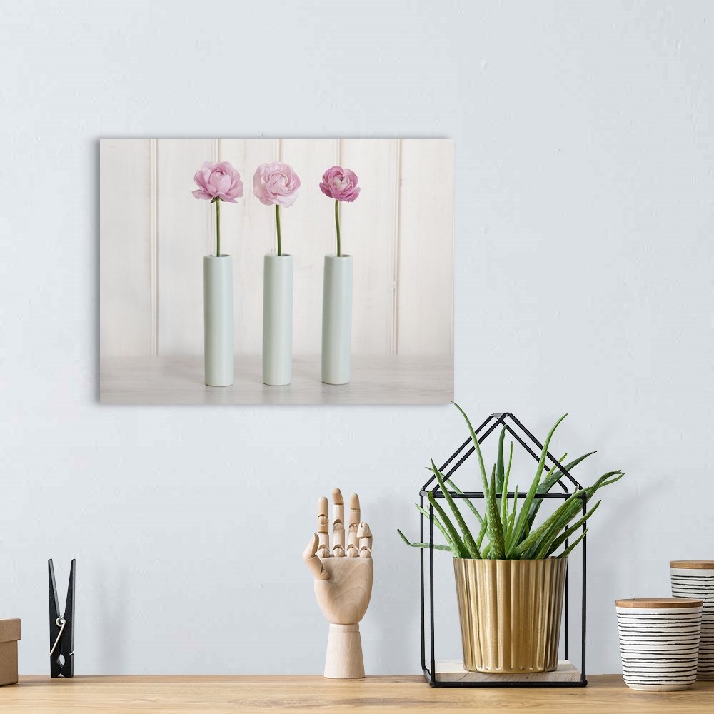 A bohemian room featuring Row Of 3 Pink Flowers In Blue Vases