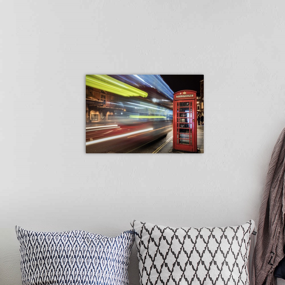 A bohemian room featuring An artistic photograph of telephone booth in London at the edge of a city street with bright neon...