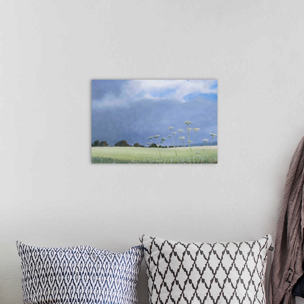 A bohemian room featuring Contemporary painting of a grassy field with parsley growing under a cloudy sky.