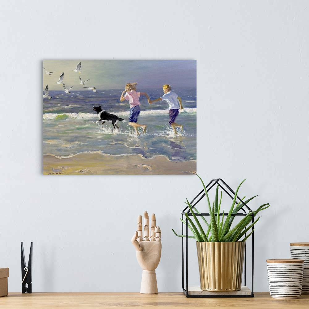A bohemian room featuring Painting of two children holding hands running on the beach as a dog chases birds in front of the...