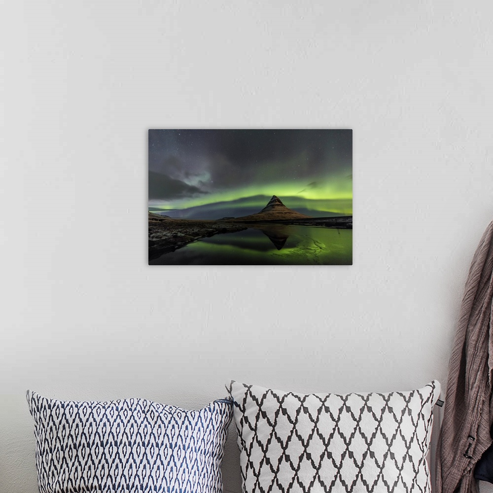 A bohemian room featuring Aurora borealis reflects below Kirkjufell aka Church Mountain on the Snaefellsnes Peninsula in we...