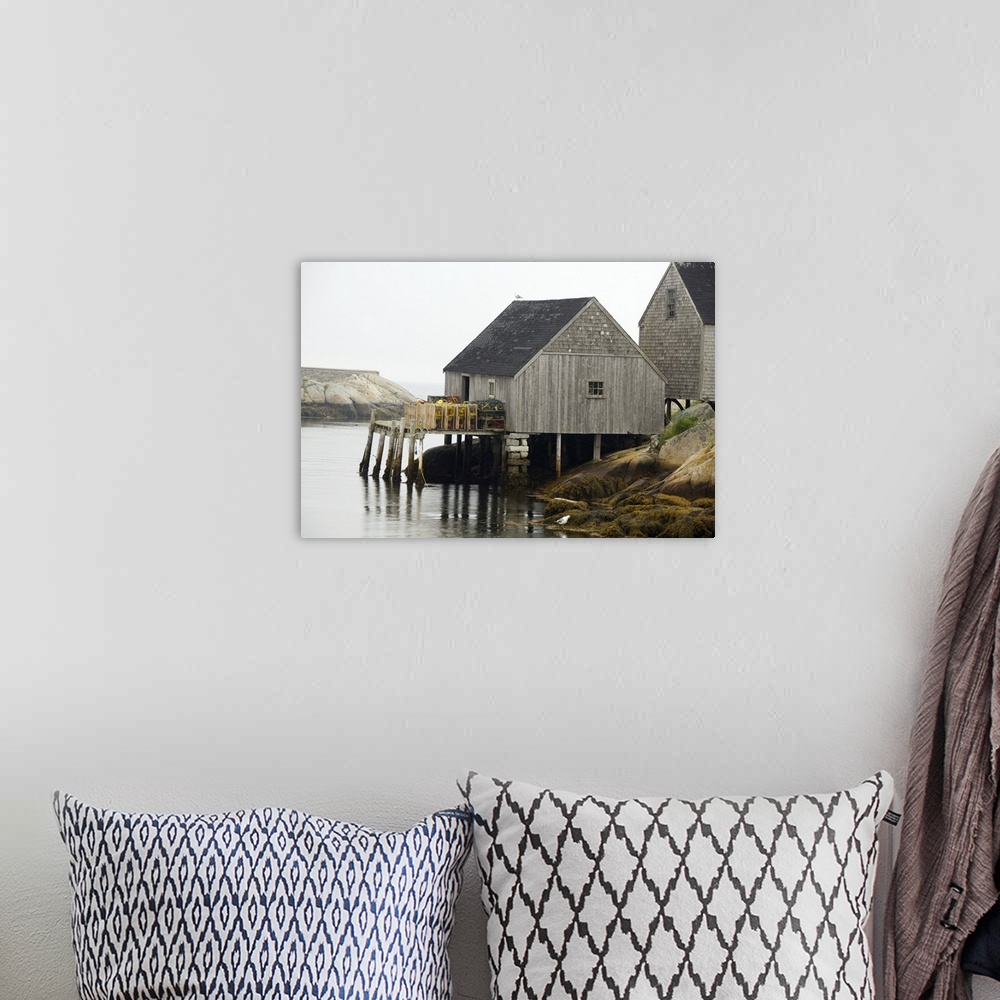 A bohemian room featuring Canada, Nova Scotia, Peggy's Cove. Lobster traps on typical wooden dock.