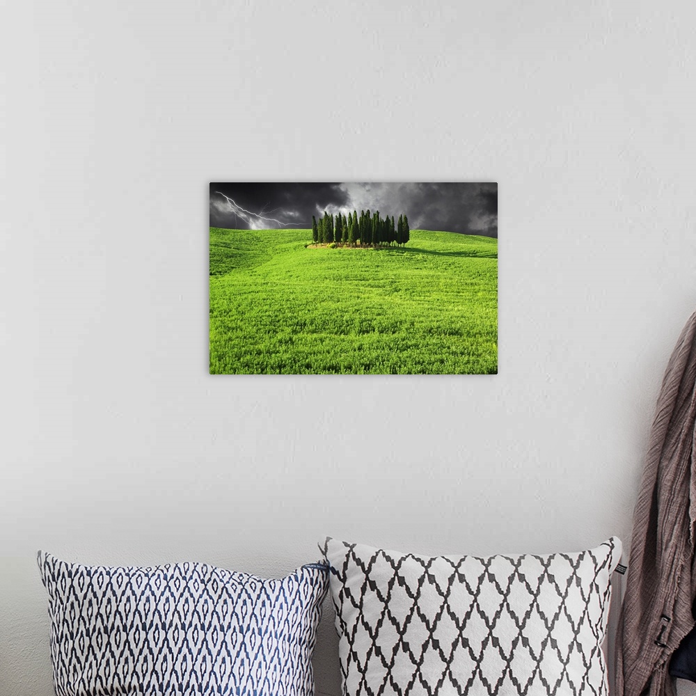 A bohemian room featuring Europe, Italy, Tuscany. Lightning behind cypress trees on hill.