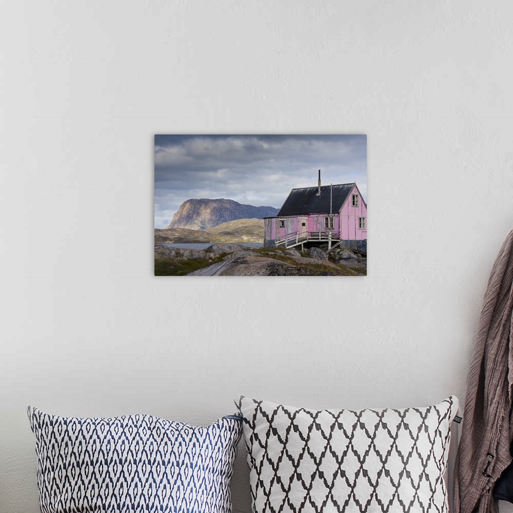 A bohemian room featuring Greenland, Itilleq. Worn pink house.