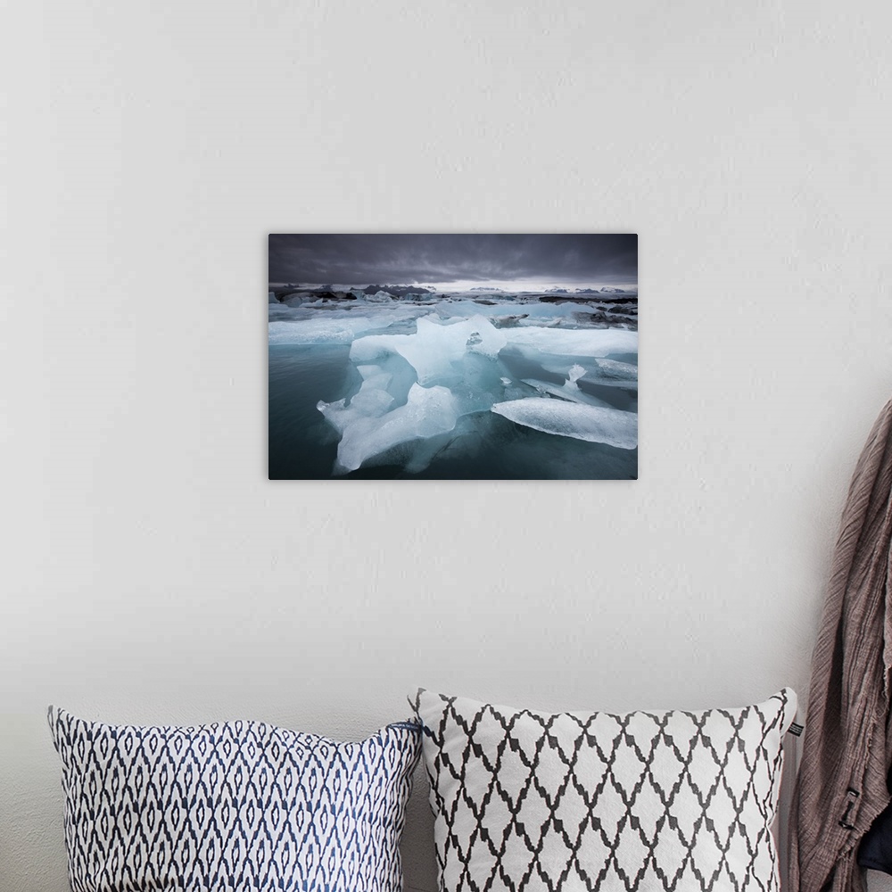 A bohemian room featuring Iceland, Skaftafell National Park, Storm clouds loom above icebergs from Vatnajokull Glacier in J...