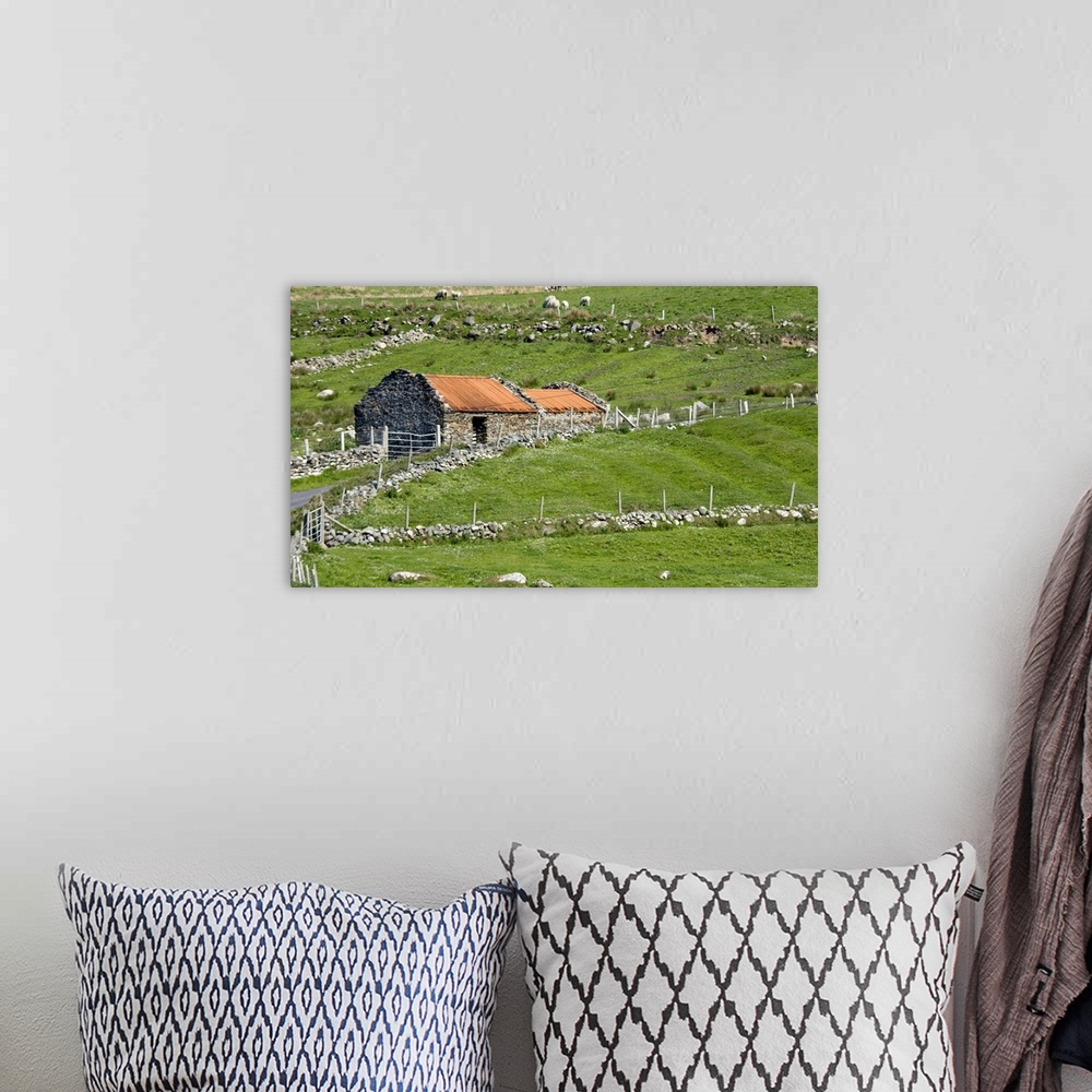 A bohemian room featuring Europe, Ireland, County Mayo, Barnabaun Point. Irish countryside with stone wall and red-roofed h...
