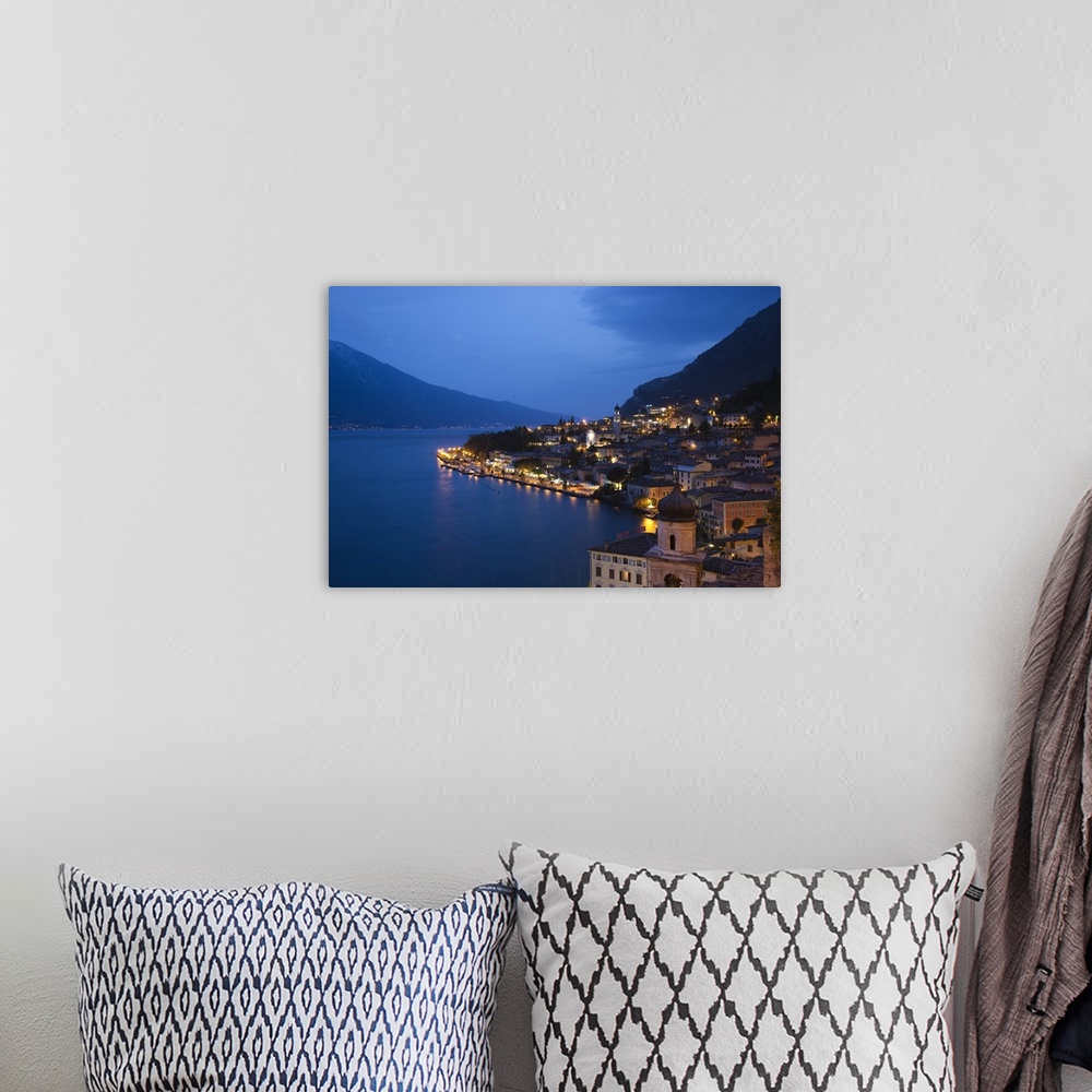 A bohemian room featuring ITALY, Brescia Province, Limone sul Garda. Aerial town view, dusk.