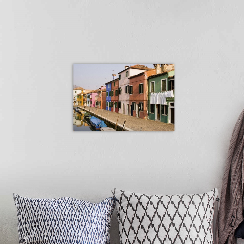 A bohemian room featuring Europe, Italy, Burano. Colorful houses of line a canal.