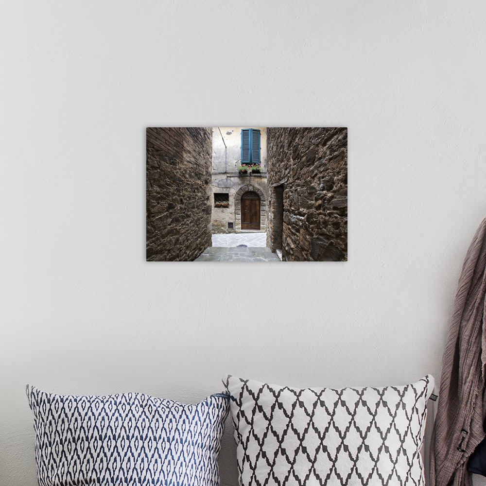 A bohemian room featuring Europe, Italy, Petroio. Narrow walkway frame a doorway in a Tuscany village.