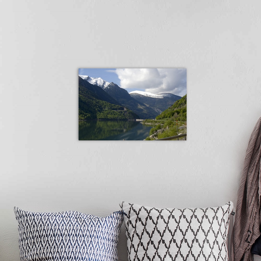 A bohemian room featuring Spain, Catalonia, Pyrenees Mountains. View of lake and dam from mountian road.
