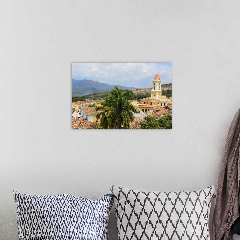A bohemian room featuring Trinidad Cuba from above tower with church and mountains with buildings of tile roofs of second o...