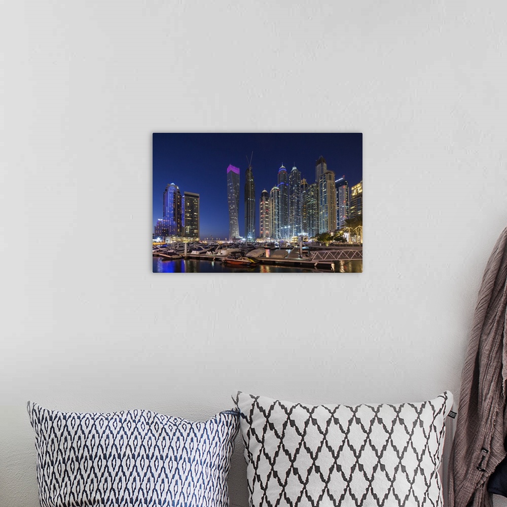 A bohemian room featuring UAE, Dubai, Dubai Marina, high rise buildings including the twisted Cayan Tower, dusk