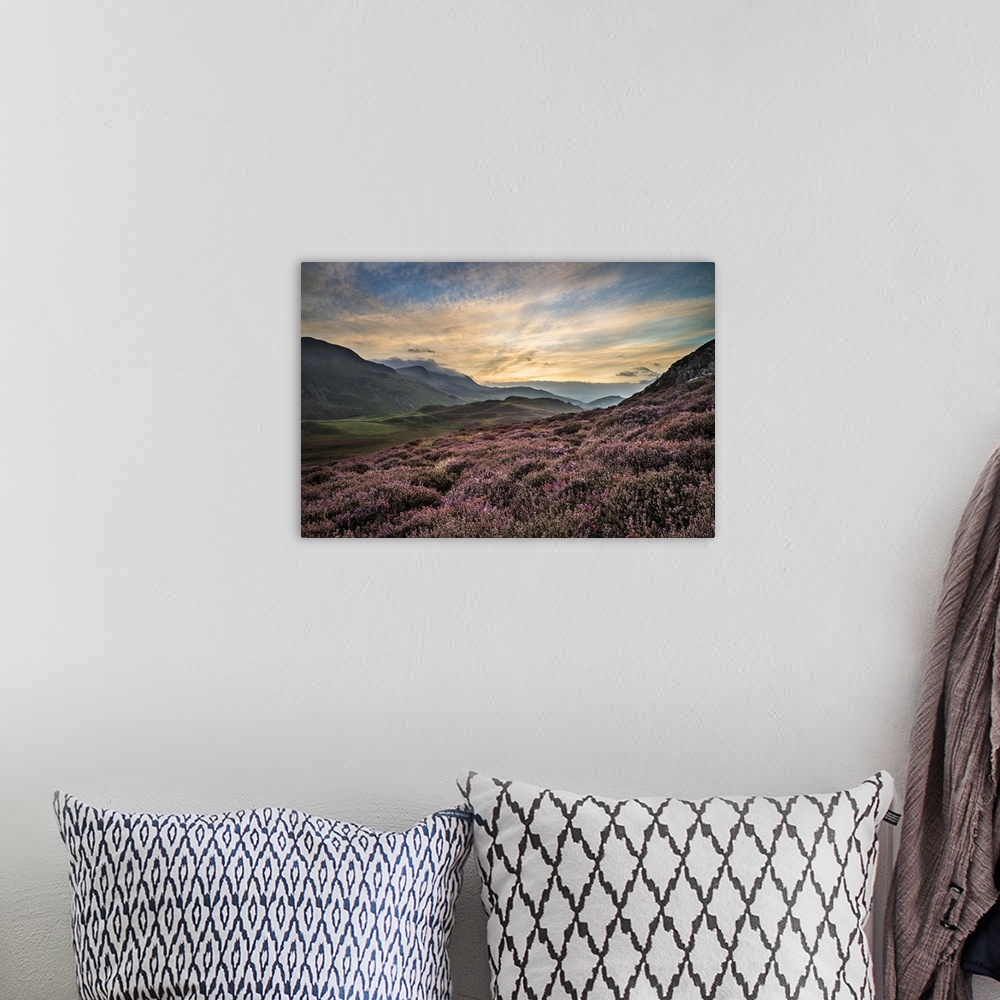 A bohemian room featuring Stunning sunrise mountain landscape with vibrant colors and beautiful cloud formations.