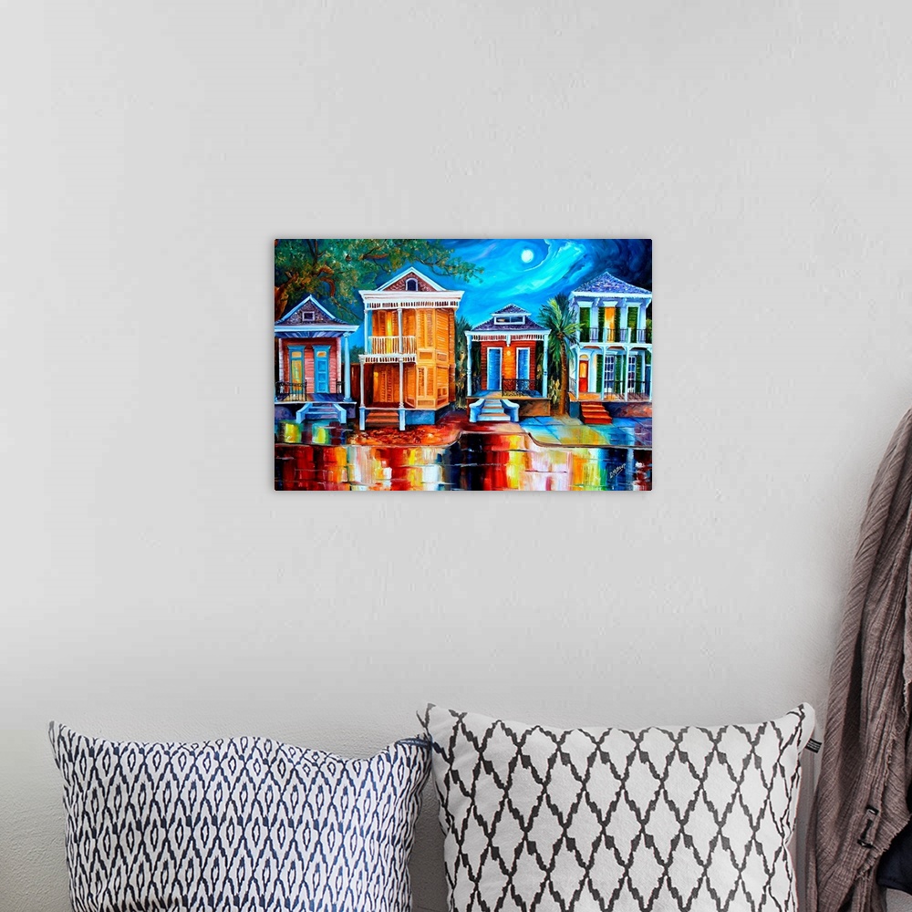A bohemian room featuring This contemporary nighttime scene features a row of historic shotgun houses in New Orleans. The b...