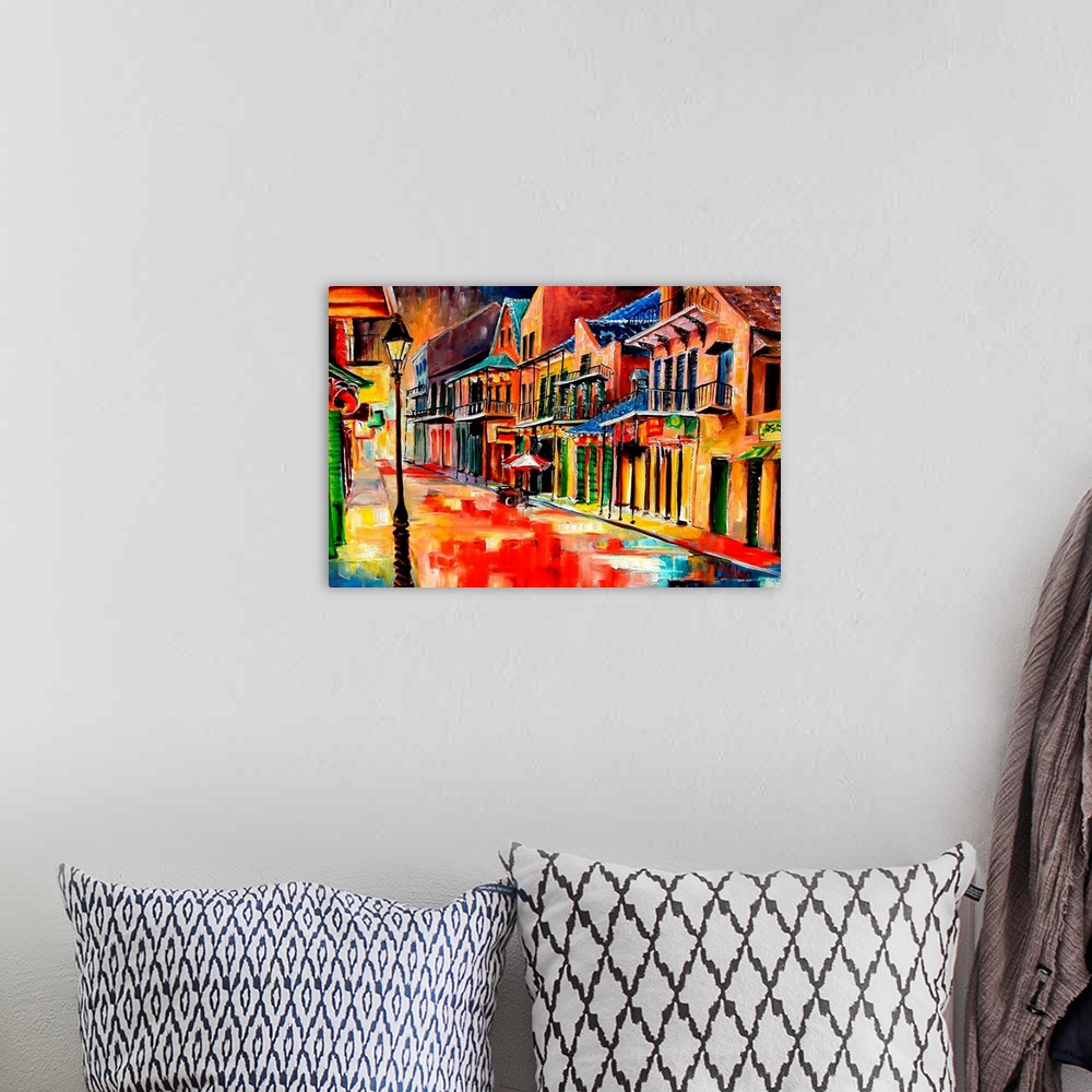A bohemian room featuring Huge contemporary art shows the vibrantly colored buildings lit up on a quiet street in Louisiana...
