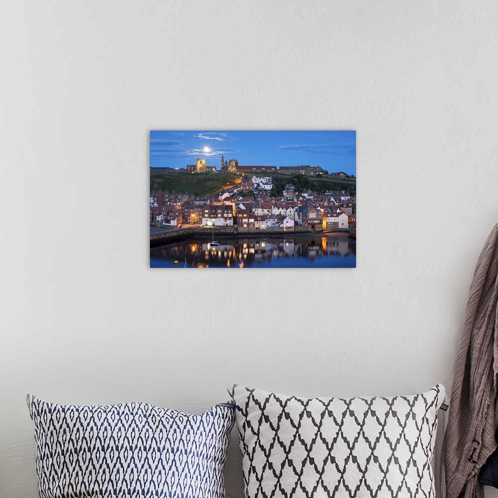 A bohemian room featuring England, North Yorkshire, Whitby, view across the town towards the abbey at night