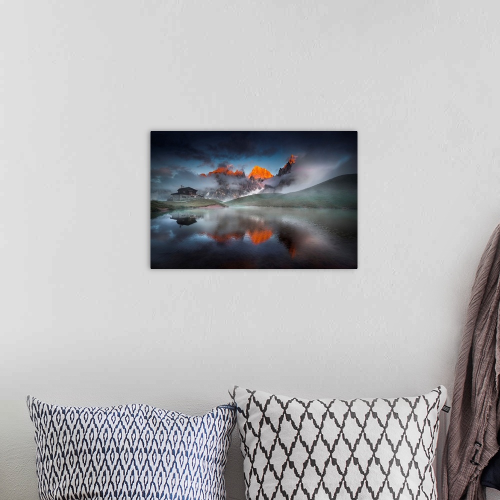 A bohemian room featuring Italy, Trentino, Pale di San Martino, reflecting on an alpine lake on a cloudy sunset.
