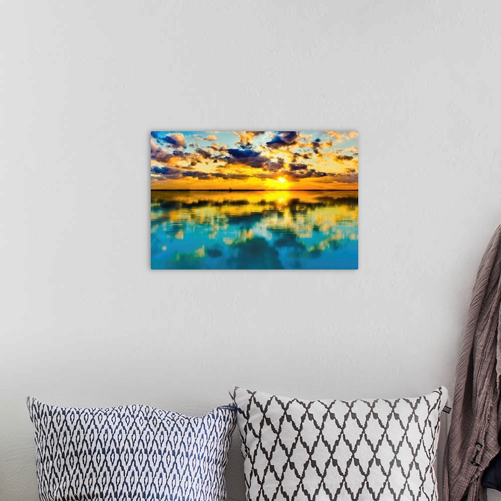 A bohemian room featuring A blue and yellow sunset lake reflection of a skyscape.