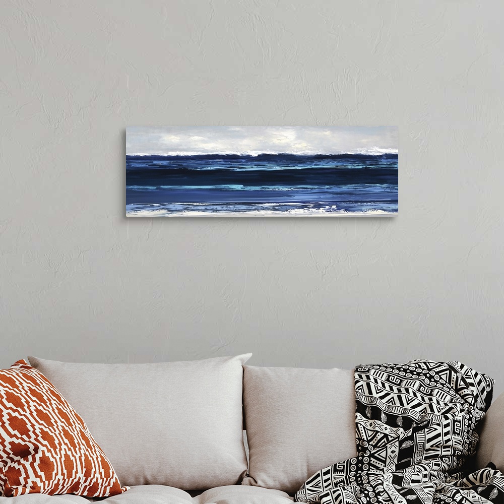 A bohemian room featuring Panoramic painting of horizontal brush strokes illustrating waves of the ocean coming to shore.
