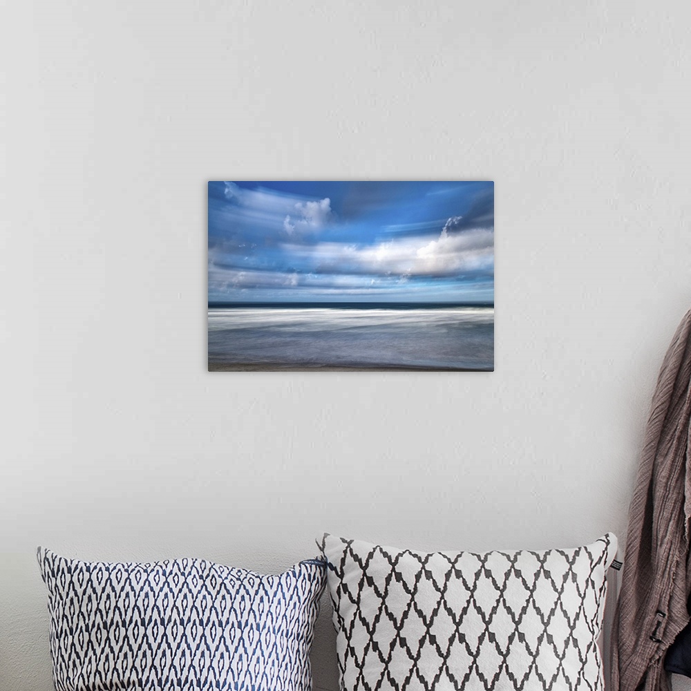 A bohemian room featuring Photograph of storm clouds at beach blurred with long exposure.