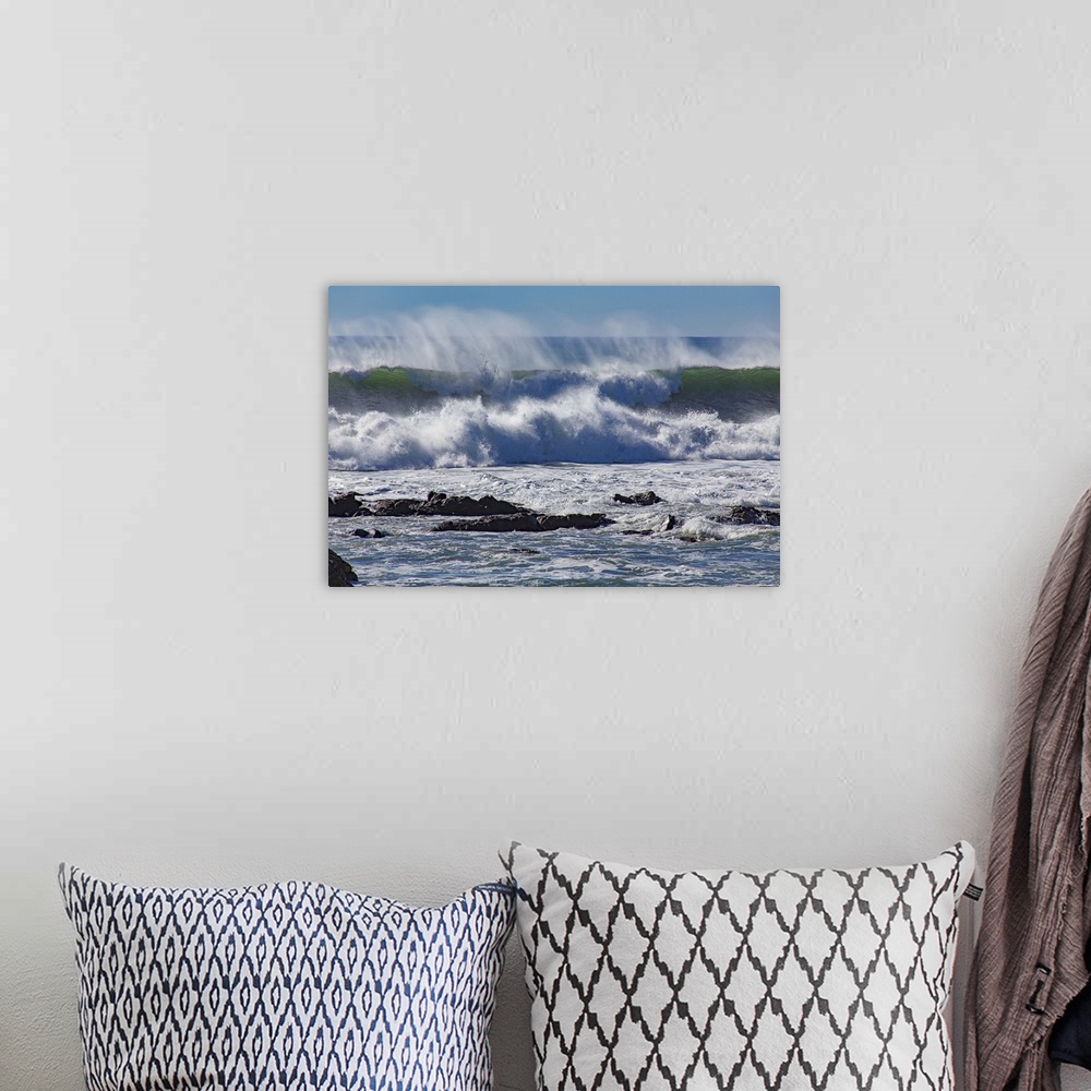 A bohemian room featuring Photograph of a big dramatic wave crashing over rocks in North Cayucos, California.