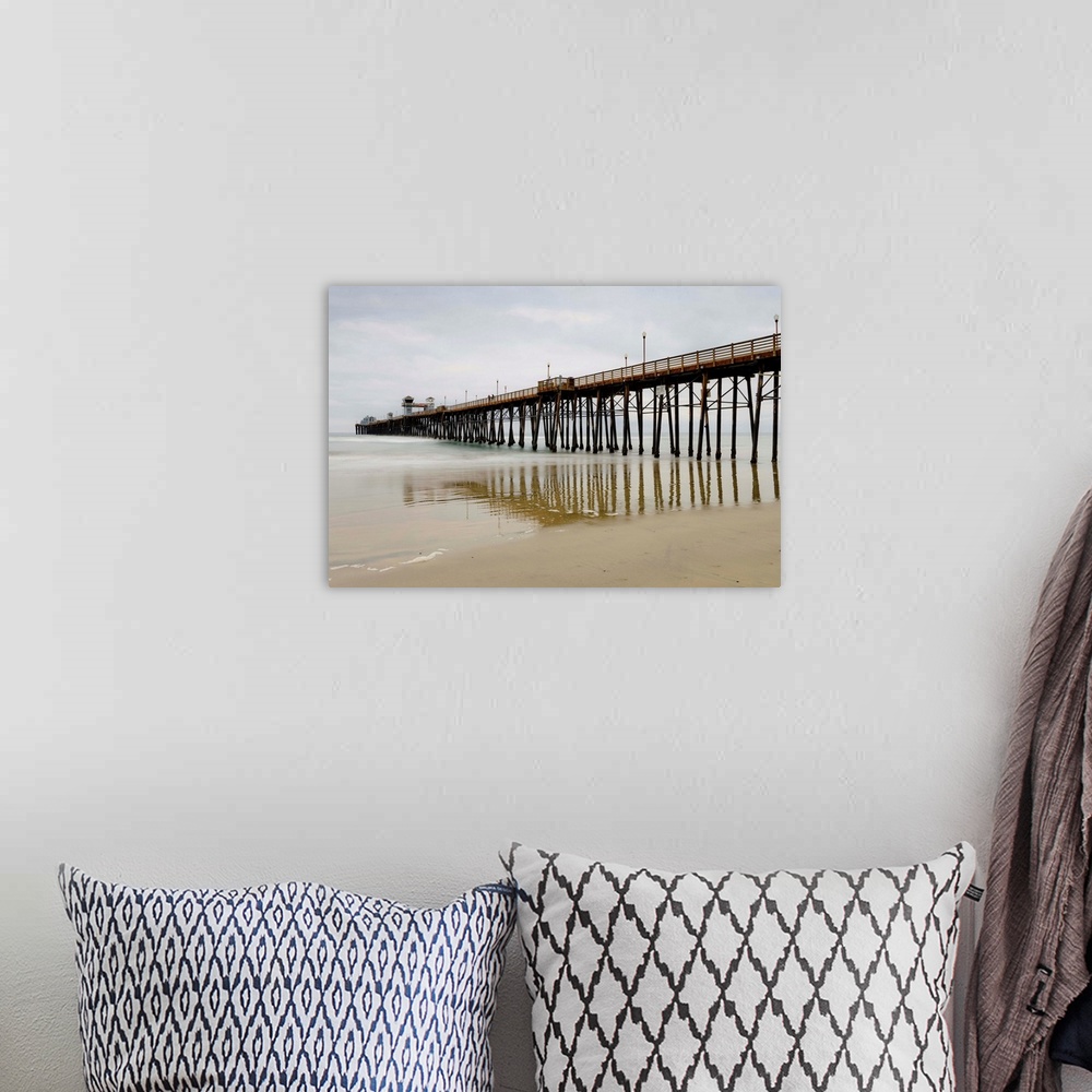 A bohemian room featuring Photograph of Oceanside Pier at low tide.