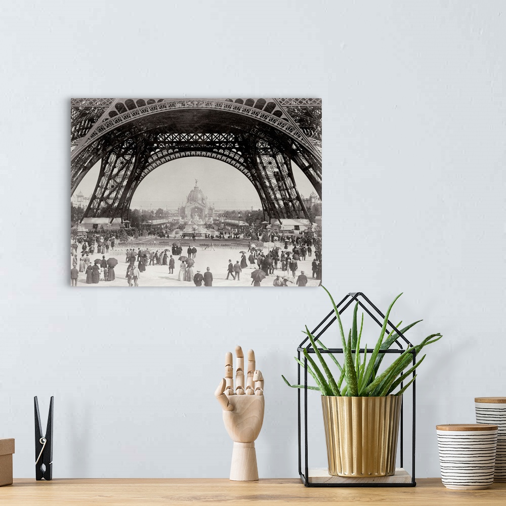 A bohemian room featuring Vintage photograph of people standing under the base of the Eiffel Tower in Paris.