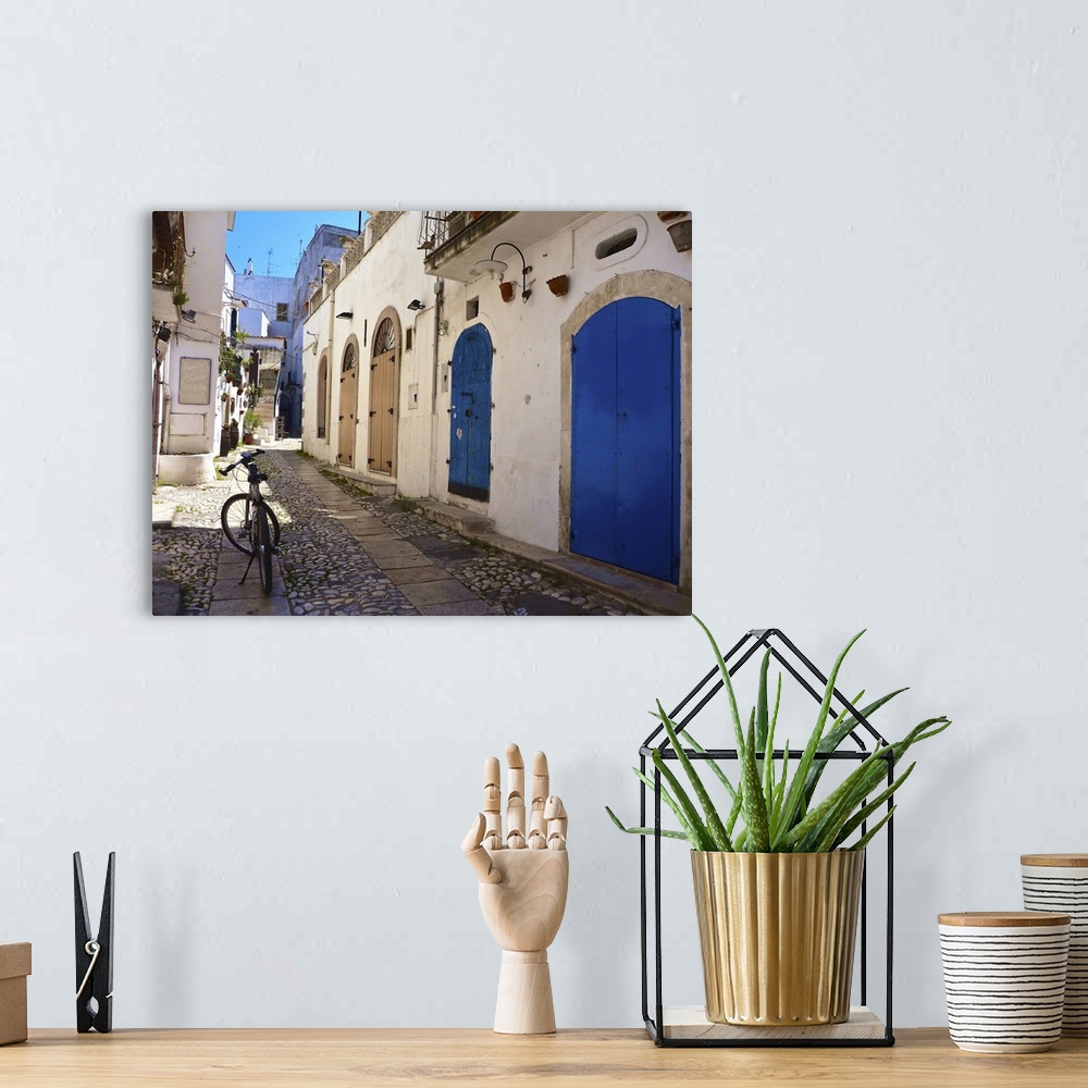A bohemian room featuring A bicycle in the middle of the street in Puglia, Italy