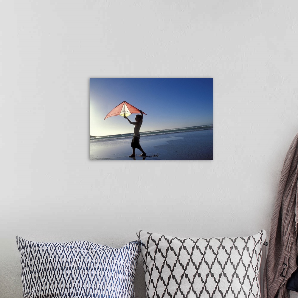 A bohemian room featuring Boy flying kite at beach