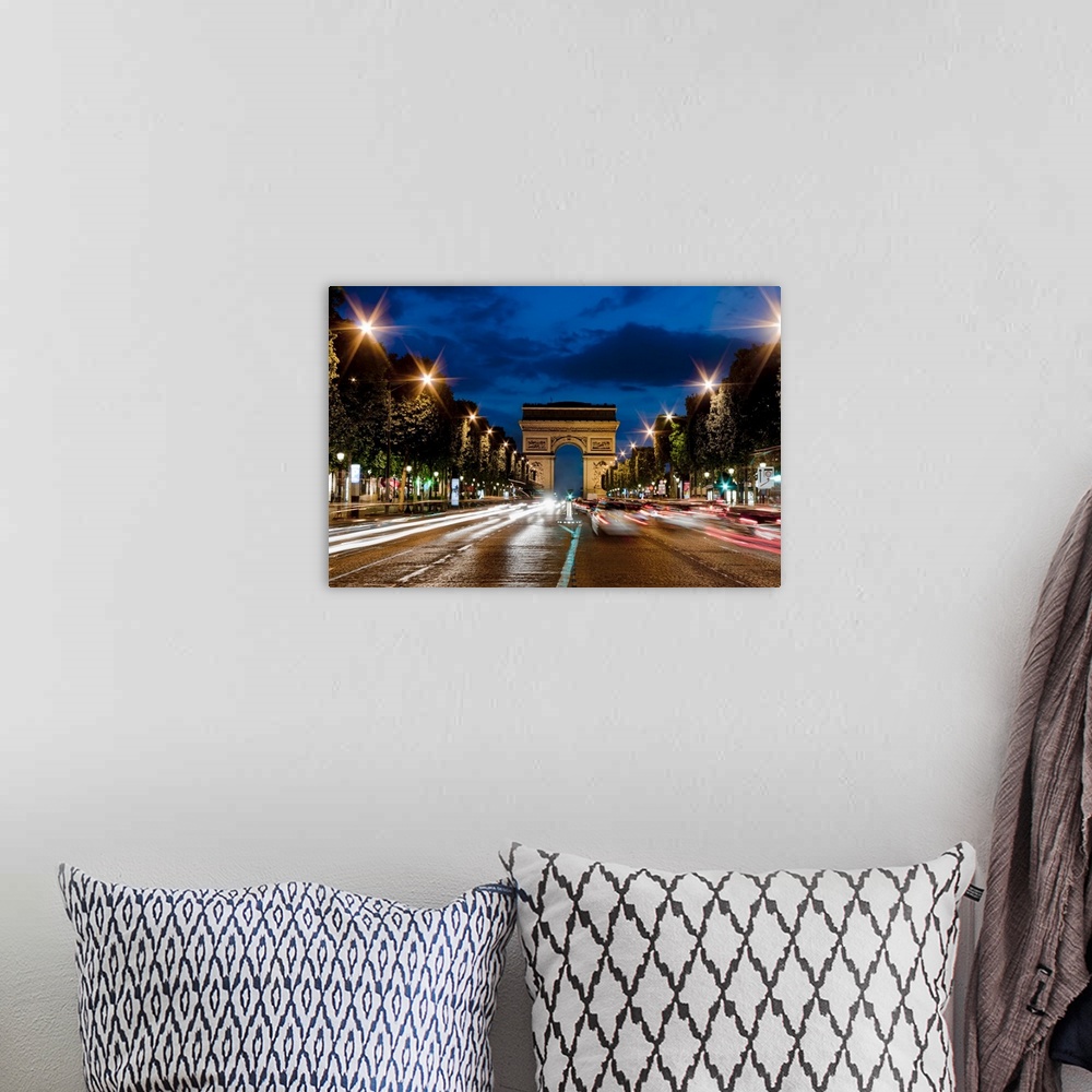 A bohemian room featuring Champs Elysees and Arc de Triomphe at dusk.