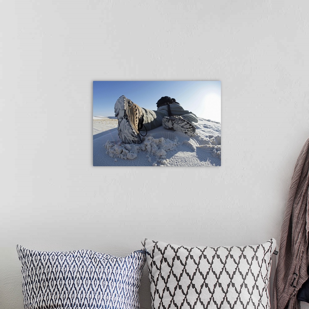 A bohemian room featuring Person climbing dune in white sands national park.