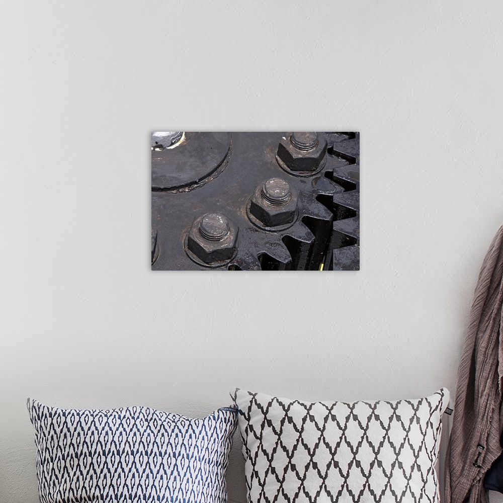 A bohemian room featuring Oversized, horizontal, close up photograph of the teeth meeting on two large metal gears. Large b...