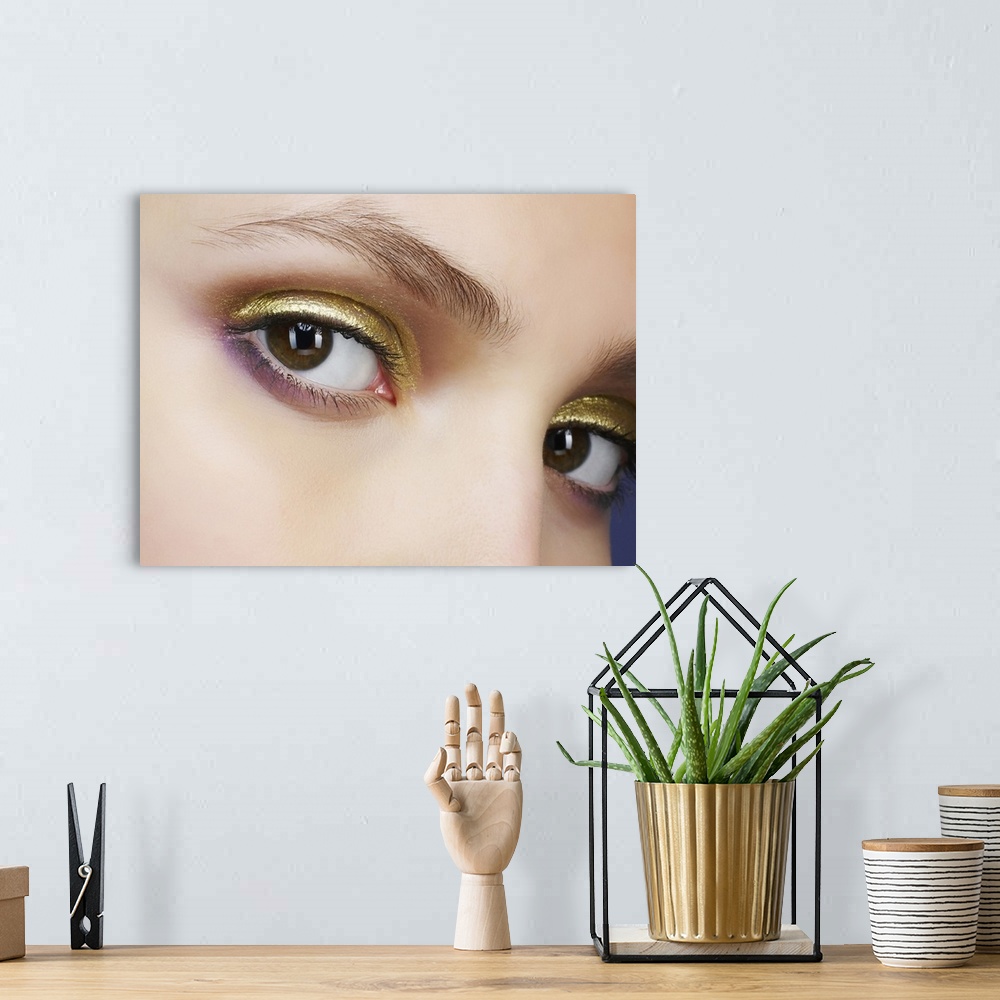 A bohemian room featuring Closeup of eyes with gold eyeshadow
