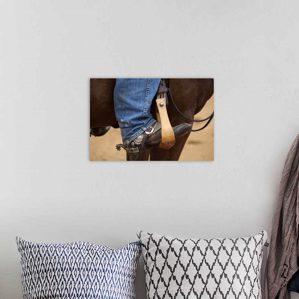A bohemian room featuring Cowboy boot in horse stirrup with spurs