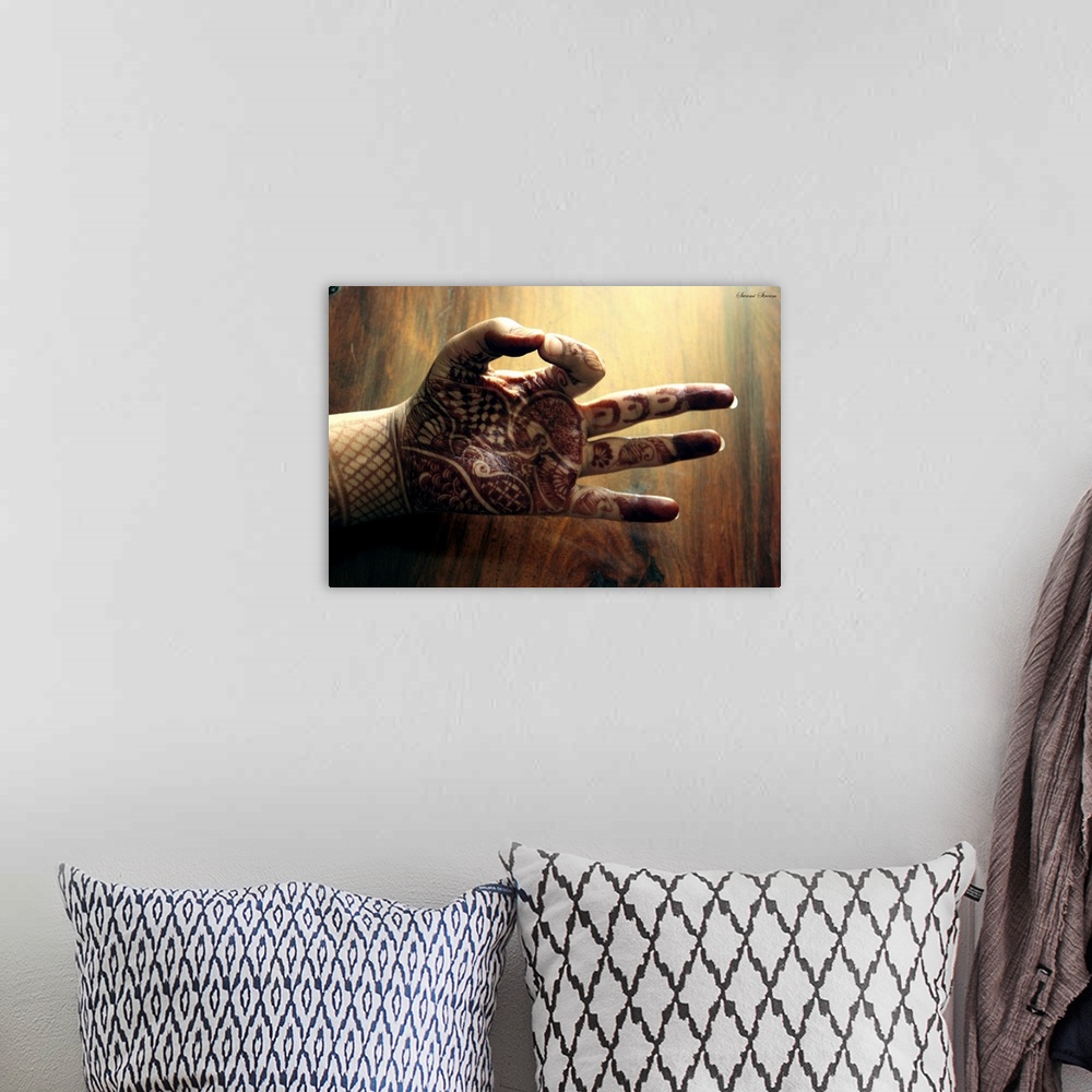 A bohemian room featuring Mudra or pose of the hand captured in morning light against wooden background.