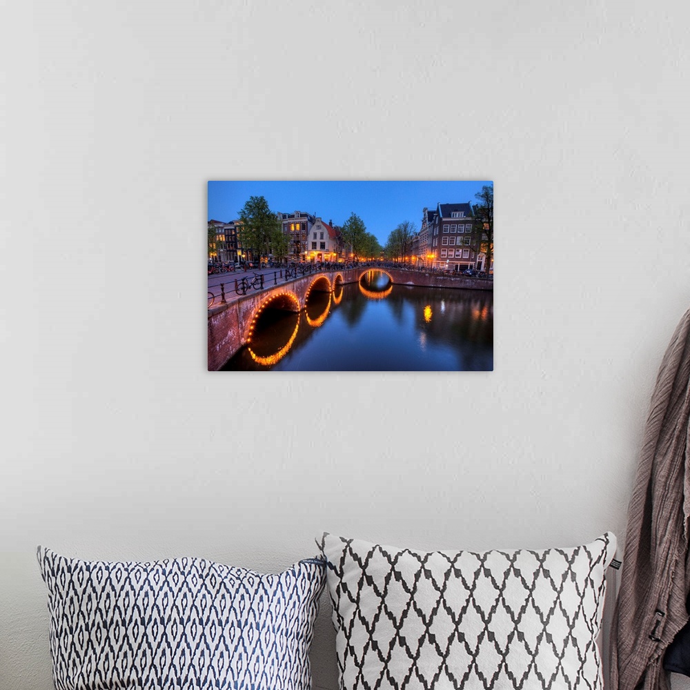 A bohemian room featuring Evening light old buildings and bridge along the many Canals of Amsterdam, Netherlands, at dusk t...