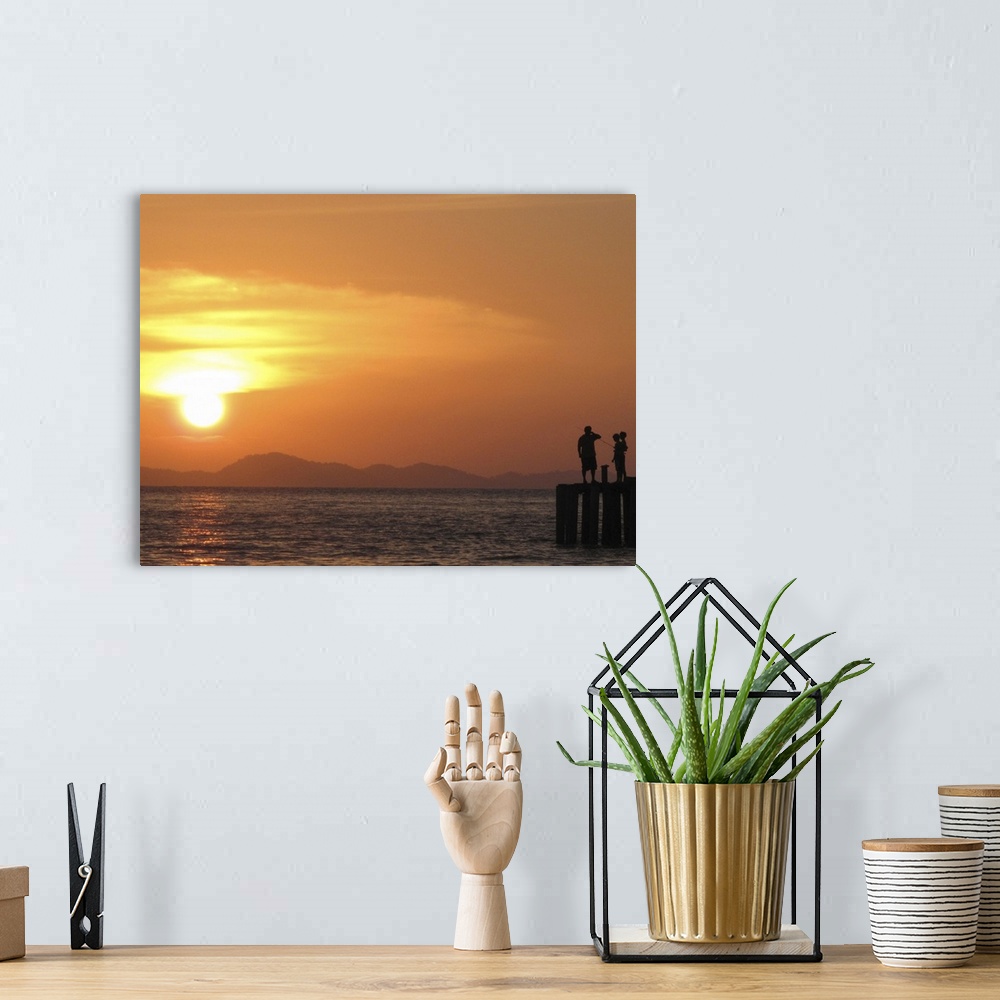 A bohemian room featuring Family watching sunset from jetty in Malaysia.