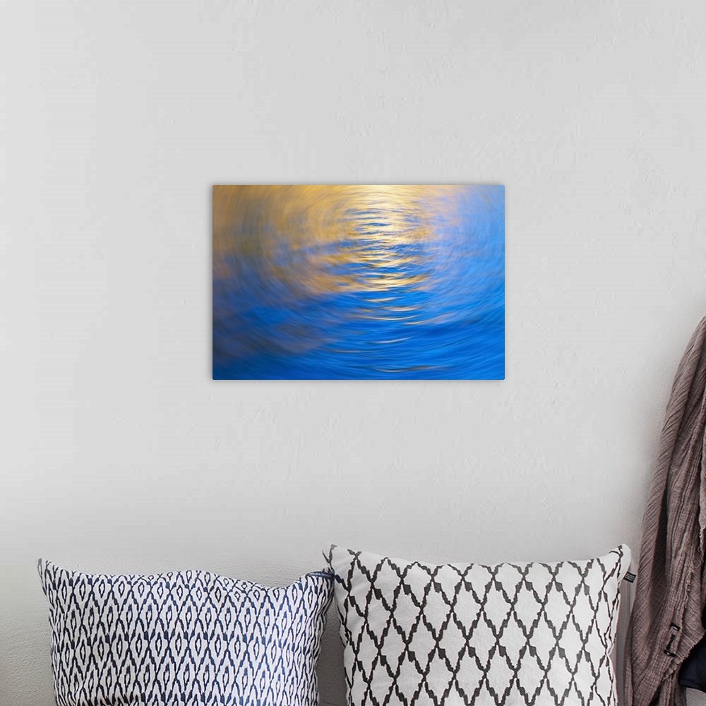 A bohemian room featuring Gently rippled water reflecting gold and blue colours, vortex.