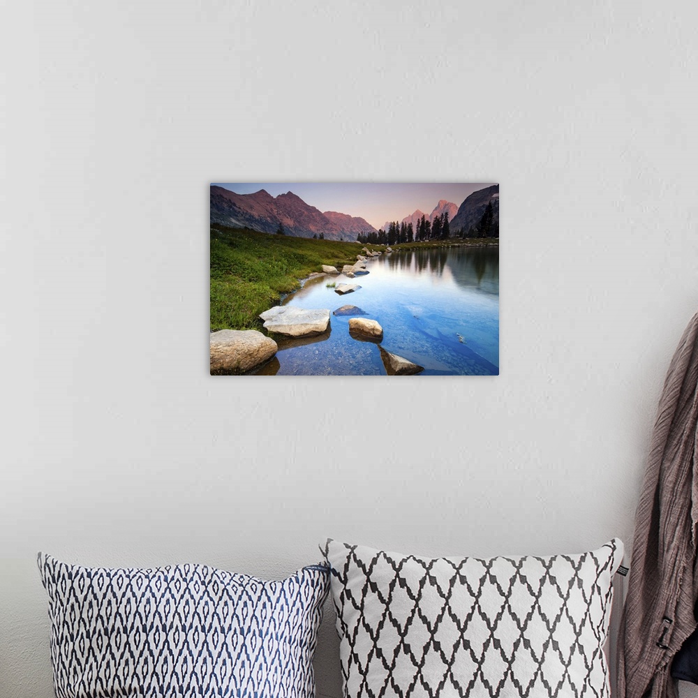 A bohemian room featuring Evening light over mountains of Teton Range reflected on still waters of Lake Solitude.