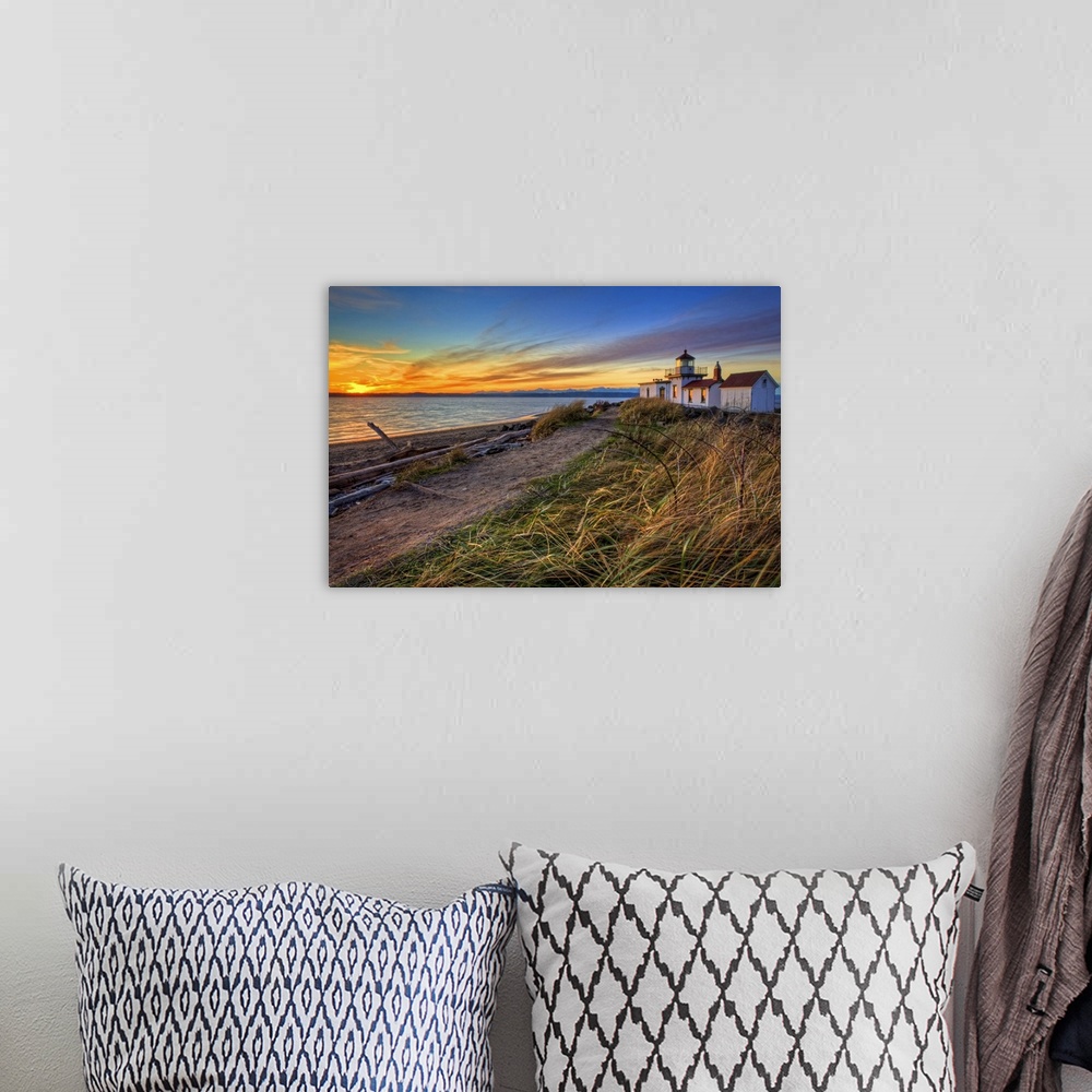 A bohemian room featuring Oversized, landscape, angled photograph of a coastline in Washington at sunset, with a lighthouse...