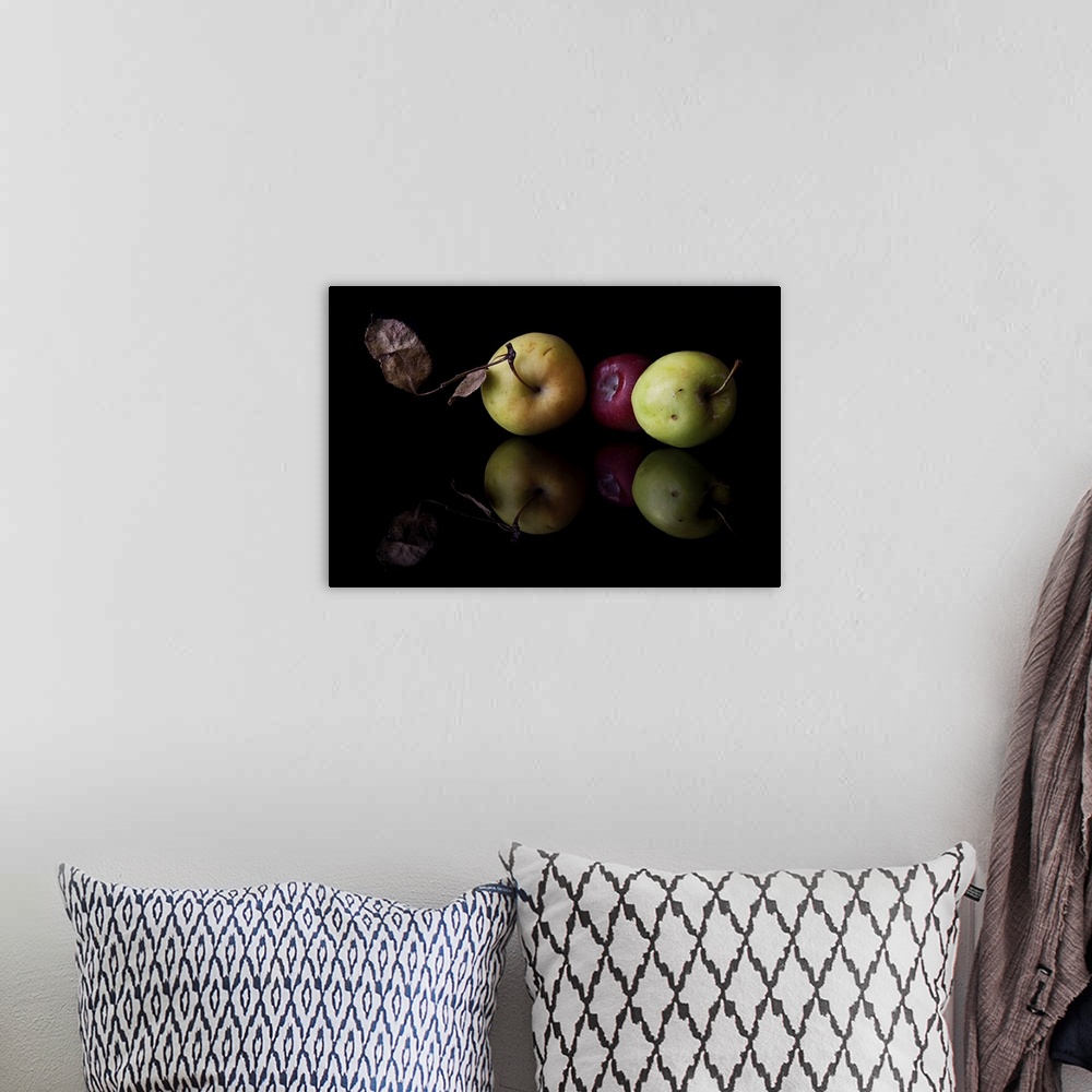 A bohemian room featuring Manzanitas fruit on black background.
