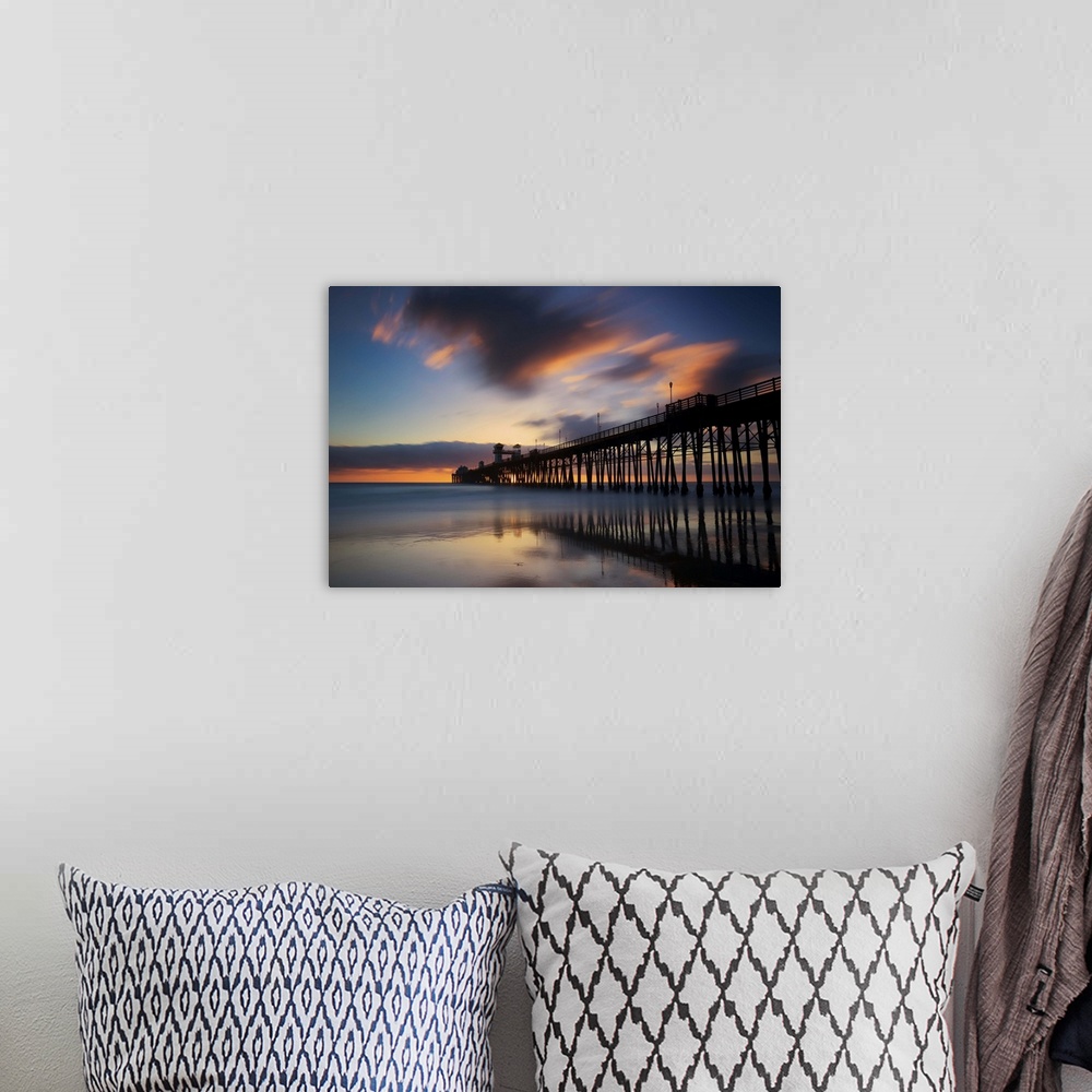 A bohemian room featuring Slow shutter speed capture of the Oceanside pier at sunset.